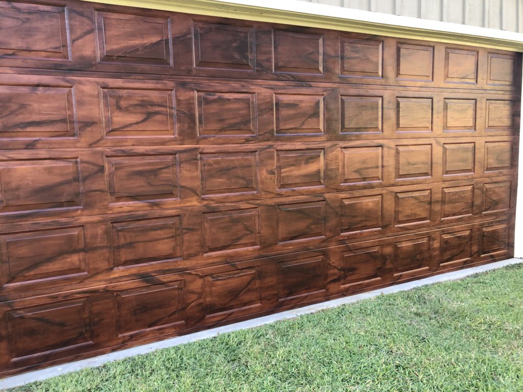 Faux wood garage door painting project, picture showing the faux wood grain on a metal garage door