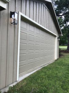 Tan garage doors before the faux wood garage door painting project