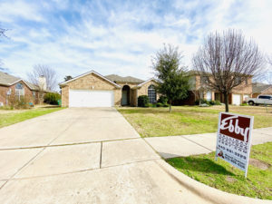 Recently reroofed house by Red Ladder Roofing before real estate closing with a for sale sign in the yard from Ebby Halliday Realtors