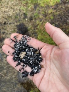 Picture of one evidence of hail damage/roof damage/shingle damage easily found in an on the ground inspection, granule loss. Picture is of hand fulls of granules found washed out by gutters.